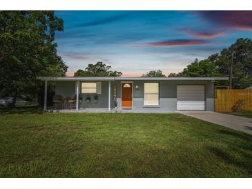 Charming single-story home featuring a well-maintained lawn and bright orange front door at 1260 S Hillcrest Ave, Clearwater, FL 33756