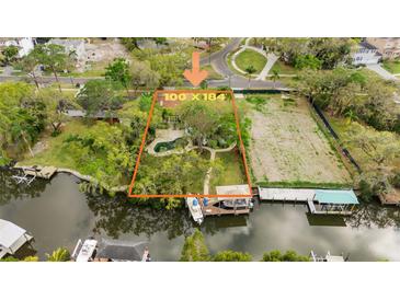 A beautiful waterfront property with mature trees, pool, and a large cleared area on a 100x184 foot lot at 2632 S Dundee St, Tampa, FL 33629