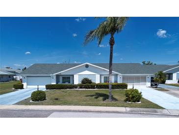 Charming single-story home featuring well-maintained landscaping and an attached two-car garage at 322 Club Manor Dr, Sun City Center, FL 33573
