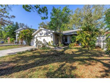Charming single-story home featuring a well-manicured lawn and attached two-car garage at 7016 2Nd N St, St Petersburg, FL 33702