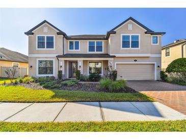 Charming two-story home with a well-manicured lawn and neatly landscaped garden beds at 19432 Whispering Brook Dr, Tampa, FL 33647