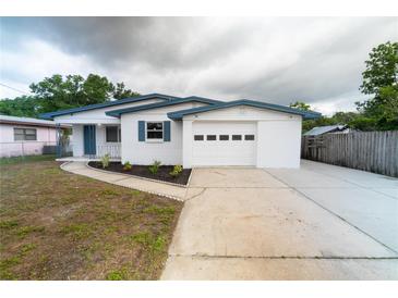 Charming single-story home boasts a freshly painted exterior, an attached garage, and a well-maintained front yard at 2610 E Yukon St, Tampa, FL 33604