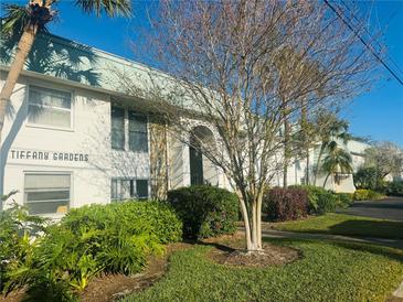 Exterior view of Tiffany Gardens showcasing the building facade, landscaping, and well-maintained grounds at 3100 Hartford N St # 221, St Petersburg, FL 33713