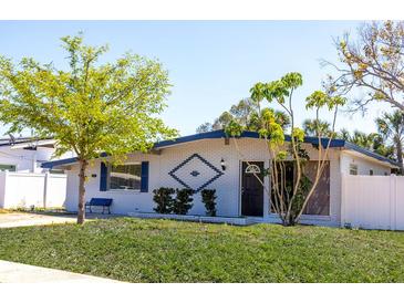 Charming single-story home featuring a well-maintained lawn and distinctive architectural details, enhancing curb appeal at 4402 Ohio Ave, Tampa, FL 33616
