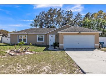 Charming single-story home featuring a well-maintained lawn, attached garage, and neutral exterior paint at 10352 Lansfield St, Spring Hill, FL 34608