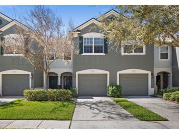 Inviting two-story townhome featuring attached garage, manicured lawn, and pleasing color scheme at 4723 Barnstead Dr, Riverview, FL 33578