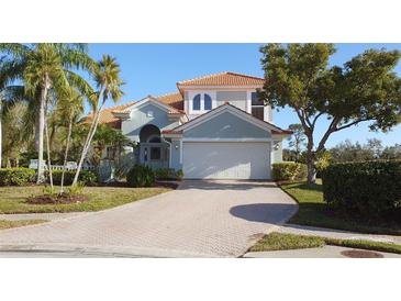 Beautiful two-story home with a tile roof, brick driveway and well-maintained landscaping at 7279 Maidencane Ct, Seminole, FL 33777