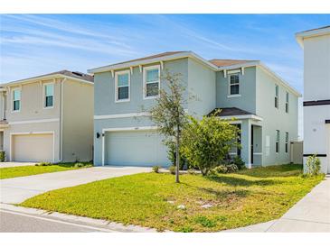 Charming two-story home features a well-manicured lawn and a two-car garage at 16051 Weathered Windmill Ter, Odessa, FL 33556