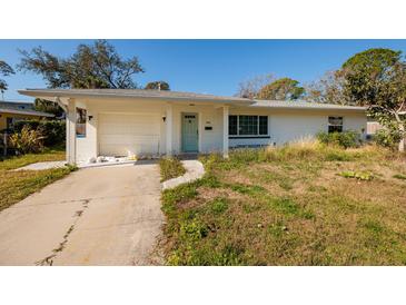 Charming single-story home with attached garage, well-lit, concrete driveway, and pleasant landscaping at 4900 Huntington Ne St, St Petersburg, FL 33703