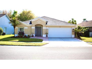Charming single-story home featuring a well-manicured lawn and attached two car garage at 5702 War Admiral Dr, Wesley Chapel, FL 33544