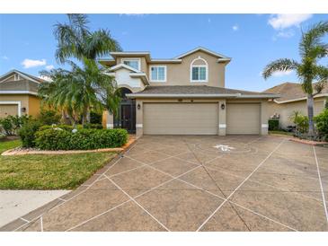 Charming two-story home boasts a three-car garage, mature landscaping, and beautiful neutral color palette at 6239 French Creek Ct, Ellenton, FL 34222