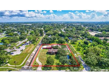 An aerial view of a rural property with a house, garden, and surrounding greenery, showing its spacious layout at 6501 62Nd N St, Pinellas Park, FL 33781