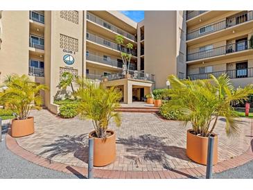 Beautiful exterior of a condo building, featuring well-manicured landscaping and a welcoming entrance at 90 S Highland Ave # 1317, Tarpon Springs, FL 34689