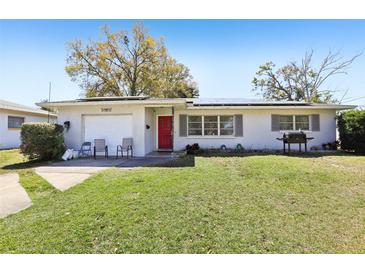 Charming single-story home with a well-maintained front yard and a vibrant red front door at 1407 Overlea St, Clearwater, FL 33755