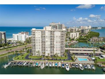 High-rise condo building with beautiful marina and ocean views on a sunny day at 1621 Gulf Blvd # 308, Clearwater Beach, FL 33767