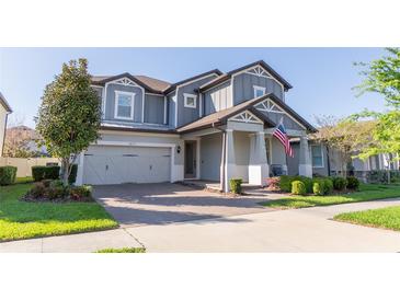 Beautiful two-story home with a well-manicured lawn, attached two car garage, and an inviting brick paved driveway at 2671 Murray Pass, Odessa, FL 33556