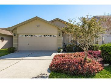 Charming home featuring a two-car garage and beautiful landscaping, enhancing its curb appeal at 2991 Covewood Pl, Clearwater, FL 33761