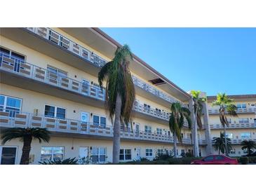 Exterior shot of a condo complex with multiple units, balconies, and palm trees at 5725 80Th N St # 314, St Petersburg, FL 33709