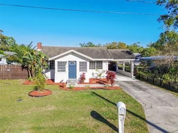 Charming single-story home with a well-manicured lawn and covered parking area at 6316 S Richard Ave, Tampa, FL 33616