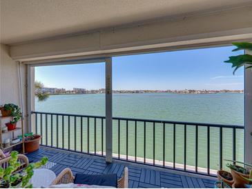 Enjoy the calming water views from this comfortable outdoor balcony with seating at 7910 Sun Island S Dr # 301, South Pasadena, FL 33707