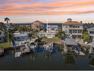 Waterfront home features a private boat dock, backyard pool, and stunning coastal views at 104 Carlyle Cir, Palm Harbor, FL 34683