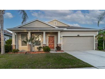 Charming one-story home with landscaped yard, covered entry, and a two-car garage at 1705 Bonita Bluff Ct, Ruskin, FL 33570