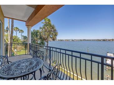 Outdoor balcony featuring a wrought iron table set, waterfront views, and access to the scenic outdoors at 17821 Gulf Blvd # B, Redington Shores, FL 33708