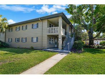 A charming two-story apartment building showcases a manicured lawn and inviting walkway at 426 32Nd N Ave # 102E, St Petersburg, FL 33704