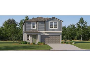 Two-story home featuring lap siding and board and batten accents, a two-car garage, and low-maintenance landscaping at 8440 Sea Ray Run, Parrish, FL 34219
