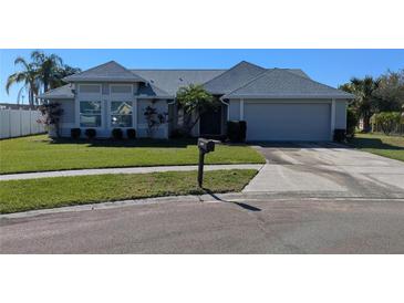 Charming single-story home featuring a manicured lawn, gray paint, and a two-car garage at 2105 Haydon Ct, Brandon, FL 33511
