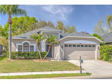 Charming single-story home with lush landscaping, two car garage and freshly cut lawn at 10641 Firebrick Ct, Trinity, FL 34655