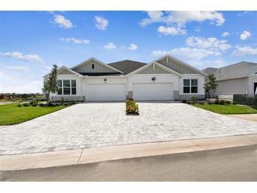 Charming home featuring a large driveway, well-manicured lawn, and beautiful architectural details at 2832 Marrakesh Ln, Sarasota, FL 34234