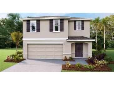 Two-story home featuring a two-car garage, neutral paint, dark shutters, and a covered front entry at 4418 Sand Dollar Way, Zephyrhills, FL 33541