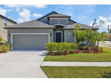 Charming single-Gathering home with a well-manicured lawn and attached two-car garage at 1050 Davis Heather Cir, Seffner, FL 33584