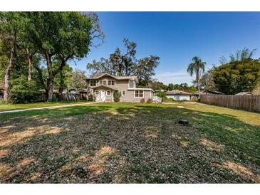 Charming two-story home with a large front yard and mature trees providing plenty of shade at 1104 E Genesee St, Tampa, FL 33603