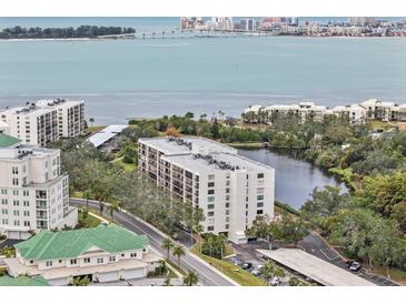 Panoramic aerial view of waterfront condo community, showcasing the building and surrounding natural beauty at 220 Belleview Blvd # 701, Belleair, FL 33756