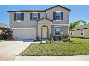 Charming two-story home featuring a well-manicured lawn and inviting front entrance at 11218 Sage Canyon Dr, Riverview, FL 33578