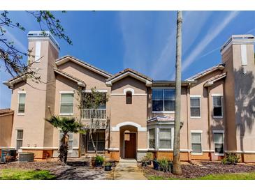 Charming multi-level condo exterior with a neutral color palette and a well-manicured front yard at 17965 Villa Creek Dr, Tampa, FL 33647