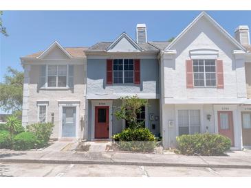 Charming townhome featuring colorful exterior with landscaped garden, and visible unit numbers at 5704 Bratton Dr # 2, Tampa, FL 33617