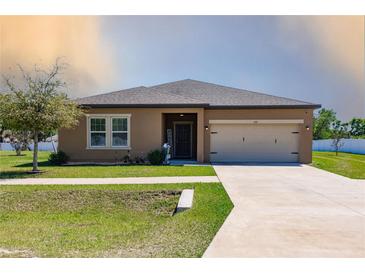 Charming single Gathering home with a well manicured lawn and two car garage at 733 Garden Oaks Sq, Seffner, FL 33584