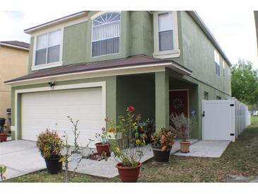 Charming two-story home with a well-maintained lawn and a two car garage at 716 Burlwood St, Brandon, FL 33511
