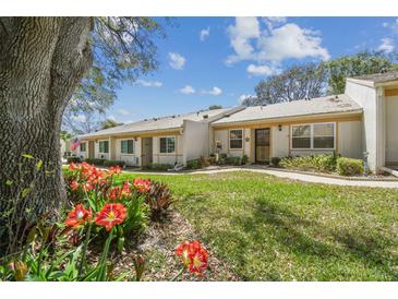 Charming single-story home with lush landscaping and a welcoming front yard at 8130 Braddock Cir # 3, Port Richey, FL 34668