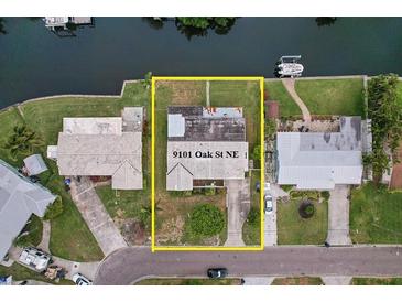 Aerial view of property at 9101 Oak St NE featuring waterfront access and lush landscaping at 9101 Oak Ne St, St Petersburg, FL 33702