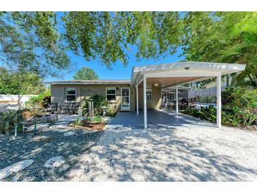 Inviting single-story home with shaded carport and landscaped front yard at 412 River S Blvd, Nokomis, FL 34275