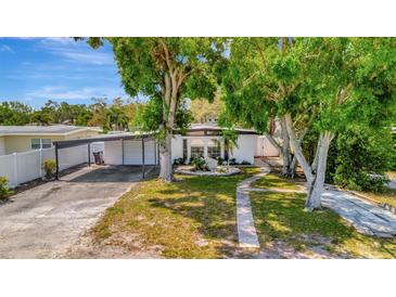Charming single-story home with well-maintained lawn and a covered carport offering curb appeal at 4720 50Th N Ave, St Petersburg, FL 33714