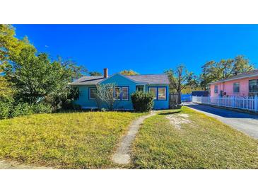 Charming blue home featuring a well-maintained lawn and inviting curb appeal on a sunny day at 860 16Th S Ave, St Petersburg, FL 33701