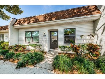 Charming home featuring a well-maintained landscaped front yard and a welcoming entrance at 9214 Mission Oaks Blvd, Seminole, FL 33776
