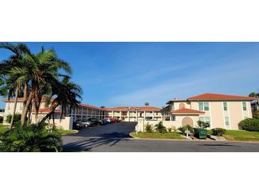 Spacious condos with ample parking, lush tropical landscaping, and beautiful blue skies overhead at 10351 Regal Dr # 18, Largo, FL 33774