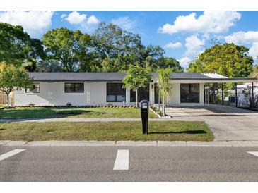 Charming single-story home with a covered carport and well-maintained front yard at 4105 W Iowa Ave, Tampa, FL 33616