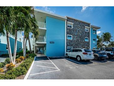 Inviting condo exterior with stone accents and parking spaces at 6201 2Nd E St # 89, St Pete Beach, FL 33706